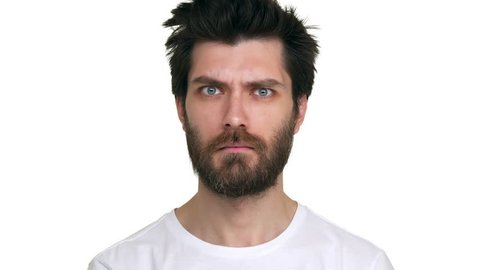 Bearded man moving eyebrows looking confident playful