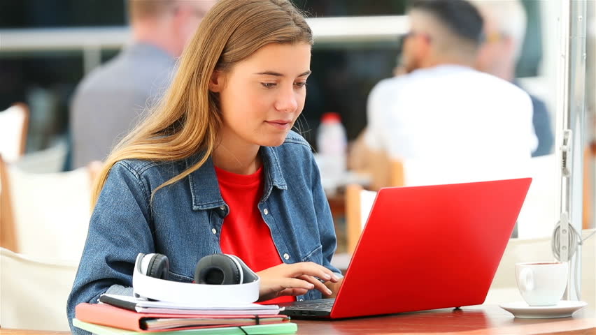 Single happy student typing in a red laptop sitting in a bar outdoors Royalty-Free Stock Footage #30490840