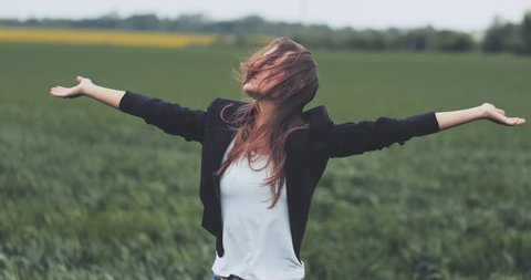 Portrait of Business Woman Standing on the Wind with Hands Up. SLOW MOTION 4K DCi. Businesswoman enjoying the wind, feeling free. Stormy weather, autumn, winter, spring.