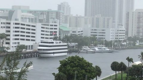 Rain and wind storm over waterway in south Florida with boat going by.