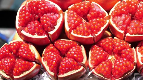 Closeup Of Red Ripe Juicy Pomegranate. Closeup. 4K. 