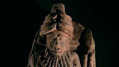 BAGHDAD, IRAQ - CIRCA 2002: Tilt-down on a painted statuette of the mythical hero Enkidu from Ur. 2nd millennium BCE. Sumerian collection Iraq Museum before it was looted in the 2003 Gulf War.