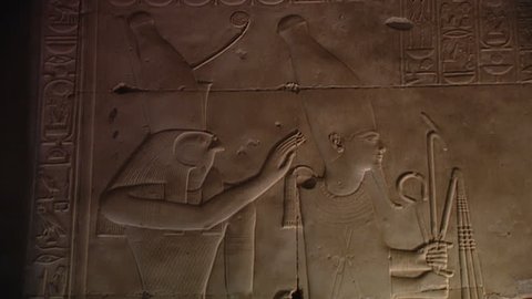 ABYDOS, EGYPT - CIRCA 2002: MCU. Horus stands behind Seti I, depicted as Osiris. The king wears the white crown of upper Egypt. Unpainted relief from the hypostyle hall (north side), Temple of Abydos.