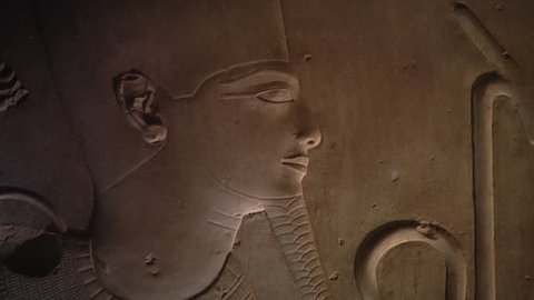 ABYDOS, EGYPT - CIRCA 2002: CU. Raised relief of head of Seti I as Osiris, with pan left to the head of Horus. Unpainted relief from the hypostyle hall (north side), Temple of Abydos.