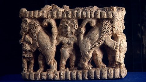BAGHDAD, IRAQ - CIRCA 2002: View of a stone carving of the hero king Gilgamesh wresting two lions by gripping their tails. Early Third millennium BCE Sumerian sculpture hall, National Museum of Iraq.