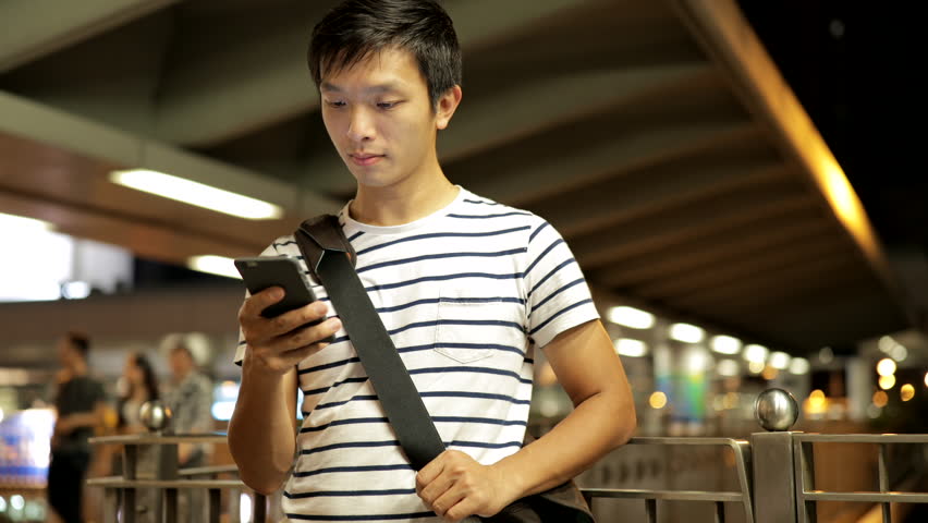 Man sms texting using app on smart phone at night