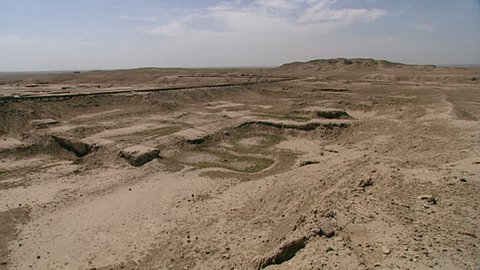 WARKA, IRAQ - CIRCA 2002: WIDE SHOT of ziggurat with Stone-Cone temple ruins in the foreground,, part of the Eanna district of Uruk. The Eanna district was dedicated to Sumerian goddess Inanna.