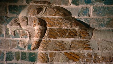 HILLAH, IRAQ - CIRCA 2002: CU replica from the Babylon site museum of the glazed brick relief of a striding lion from the palace of Nebuchadnezzar II. Original on display in the Royal Ontario Museum.