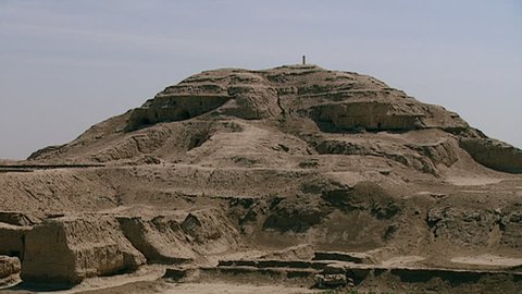 WARKA, IRAQ - CIRCA 2002: Ziggurat with Stone-Cone temple ruins in the foreground, part of the Eanna district dedicated to Sumerian goddess Inanna. Uruk is one of the first cities in history.