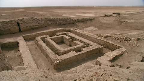 WARKA, IRAQ - CIRCA 2002: WIDE SHOT of White Temple (originally built atop the Anu Ziggurat) and Stone Building ruins. Part of the Anu district of ancient Uruk, dedicated to the Sumerian sky god Anu.