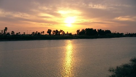 View of the sunset's reflection in the waters of the Euphrates. It is the longest river in Western Asia and one of the defining rivers of Mesopotamia.