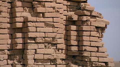 TELL EL MUQAYYAR, IRAQ - CIRCA 2002: Archaeological site of Ur. CU pan on the remains of an arched mudbrick wall with niche facade architecture. Ur was an important city-state in ancient Mesopotamia.