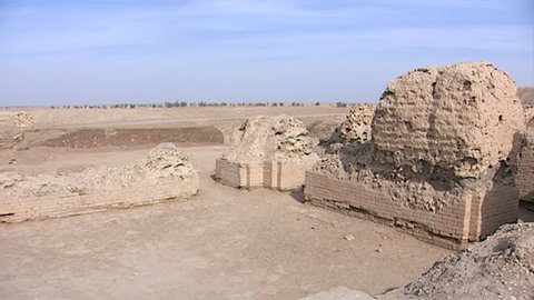 TELL EL MUQAYYAR, IRAQ - CIRCA 2002: Archaeological site Ur. pan-left across the Royal Cemetery at Ur excavated by Leonard Woolley to a crumbling mudbrick wall.