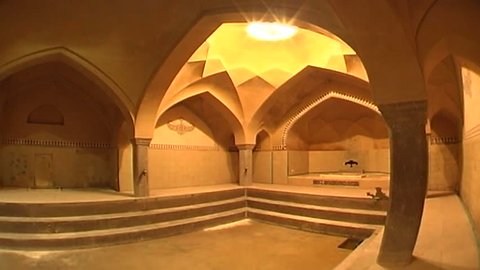 ISFAHAN, IRAN - CIRCA 2005: Pan left in a wide panoramic view of the vaulted pool room and skylight of the Safavid era bath house. The murals on the walls are a 19th century addition.