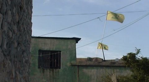 NABATIEH, LEBANON - CIRCA 2005: Hezbollah flags fluttering in the breeze. Hezbollah is a Shia Islamist political, military and social organisation that wields considerable power in southern Lebanon.