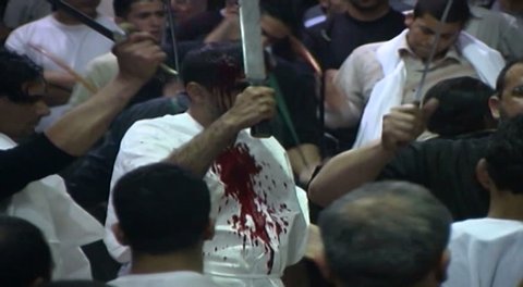 NABATIEH, LEBANON - CIRCA 2005: Ashura procession. Shia men performing Tatbir, an act of mourning which includes striking oneself with a sword causing blood to flow in remembrance of Hussain Ibn Ali.