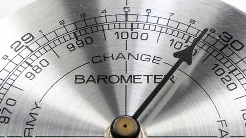Barometer pointing towards weather change macro detail with zoom.