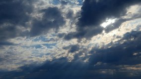 Sun rays shine through rain clouds. Beautiful timelapsed sunset through moving layers of clouds as a weather background. Sunset clouds. 4K, UHD, Timelapse. Beams of sunshine filter through clouds  - Powered by Shutterstock - Get 15% off with code: PIKWIZARD15