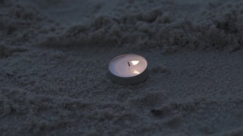 Candle on the beach