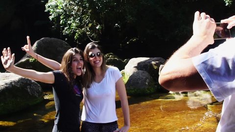 Sisters taking a selfie on Waterfall on Ilhabela, Sao Paulo, Brazil