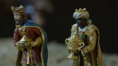 Closeup of the three kings with their gifts adoring the Child Jesus. Nativity scene figurines. Christmas traditions.