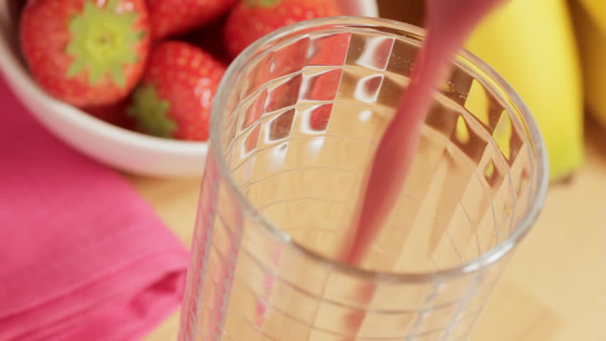Pouring fruit smoothie overhead