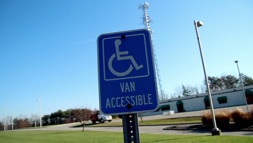 Dramatic drive-up to a handicapped parking sign.