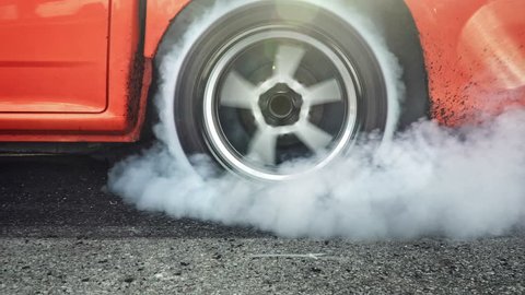 Drag racing car burns rubber off its tires in preparation for the race