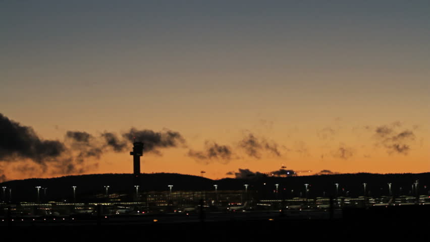 Airplane landing at airport in silhouette view