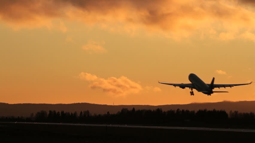 Airplane takeoff into evening sky