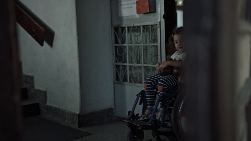 Young father taking care of his disabled child on a wheelchair | Shutterstock HD Video #30571171