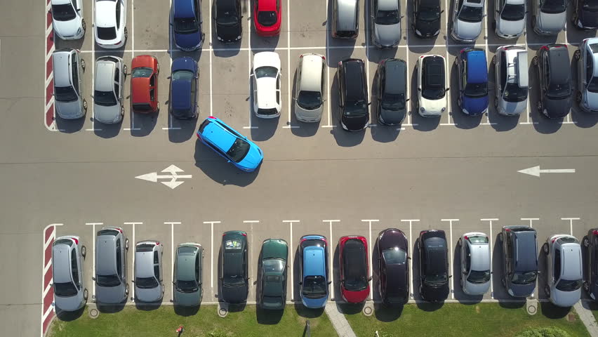 AERIAL TOP DOWN, TIMELAPSE: Bad driver incapable to park a car on parking space in big crowded parking lot. Driver having problems, unable to park a car in parking spot. Parking fail on parkspace