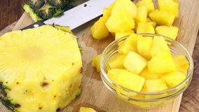 Sliced Pineapple on a rotating wooden plate (seamless loopable; 4K)
