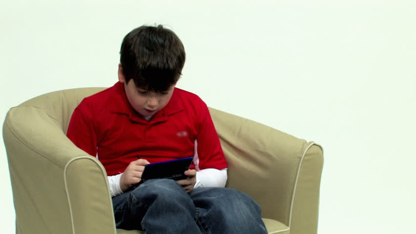 A young boy plays a hand-held video game.