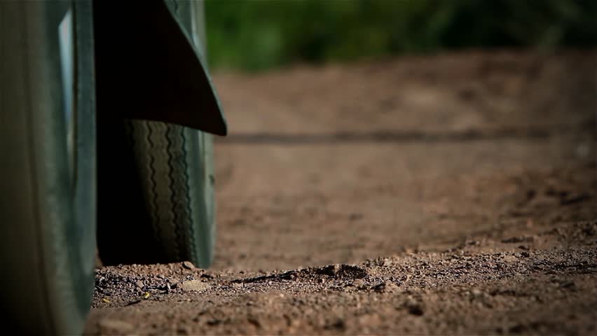 An Elderly Man wearing Sandals getting out of Car at the Beach. Ground Level View. Close Up.