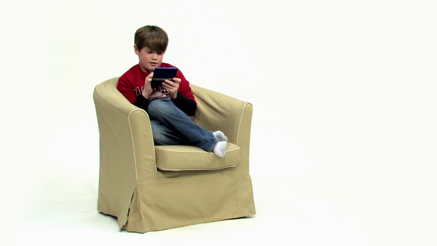 A young boy plays a hand-held video game.