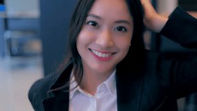 Scene slow motion of mature happy beautiful asian businesswoman smiling in the office