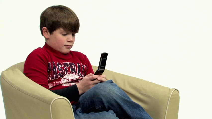 A young boy texts on his mobile cell phone.