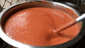 Making homemade spicy sauce by boiling in stainless pot