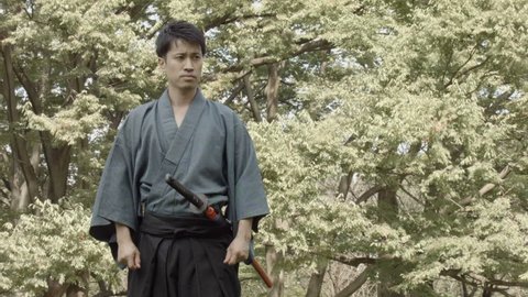Japanese Samurai draws the sword called Katana, and slashes like dancing.