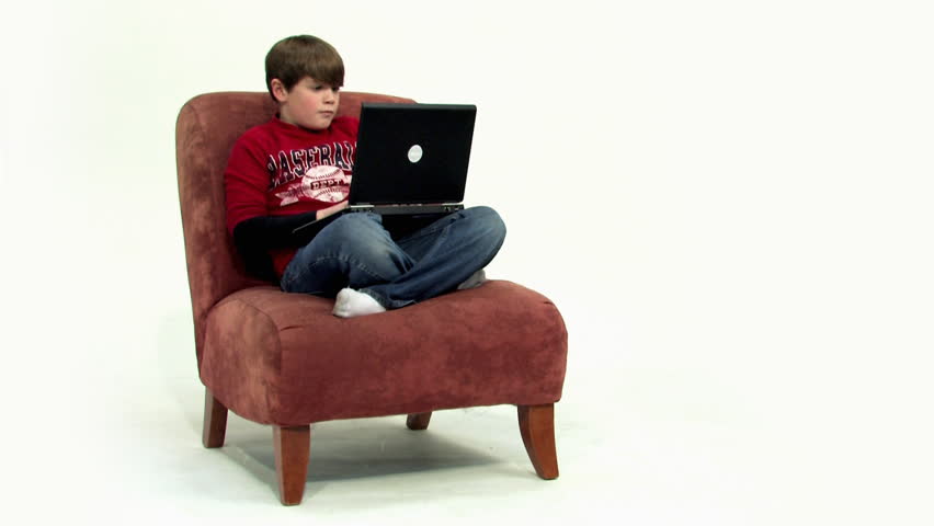 A young boy uses his laptop.