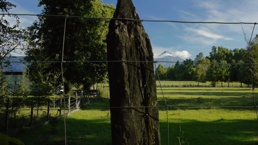 slider shot of volcano in the background of a scenic pasture