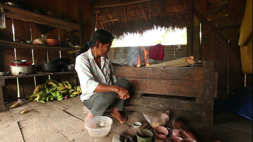 Adult woman making pottery , rural scene in ecuadorian Amazonia, color