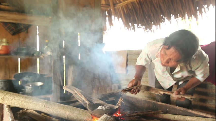 Adult woman making pottery , rural scene in ecuadorian Amazonia. Temperature is