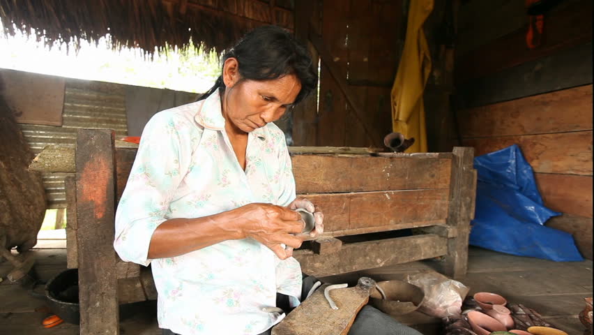 Adult woman making pottery , rural scene in ecuadorian Amazonia