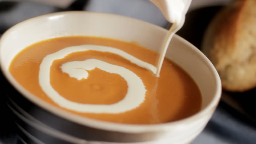 Swirling cream onto tomato soup
