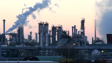 Oil and gas refinery at twilight - factory smoke stack  - Time lapse