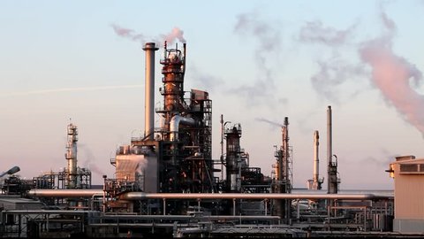 Oil and gas refinery at twilight - factory smoke stack  - Time lapse