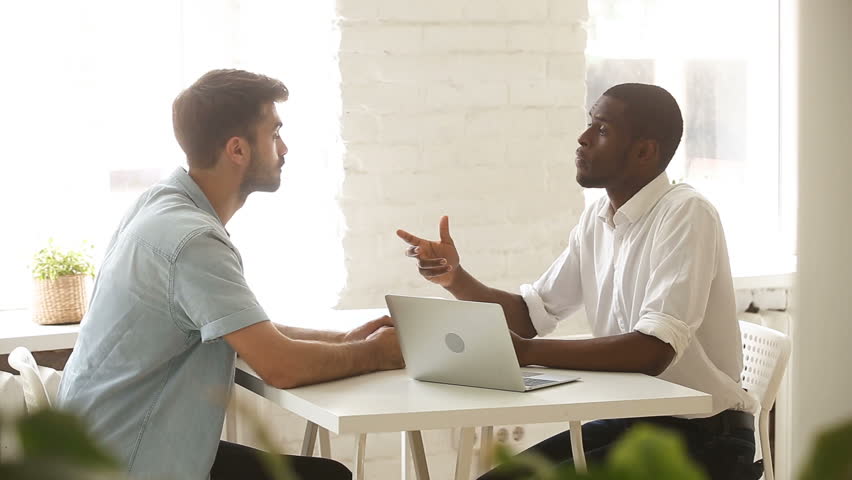 African american and caucasian young businessmen negotiating sitting at office desk with laptop, two satisfied partners close successful business deal with investor, handshake after making agreement Royalty-Free Stock Footage #30602848