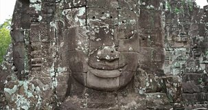 Cambodia. Angkor - Famous stone faces on the towers of the ancient Bayon temple. Video 4k